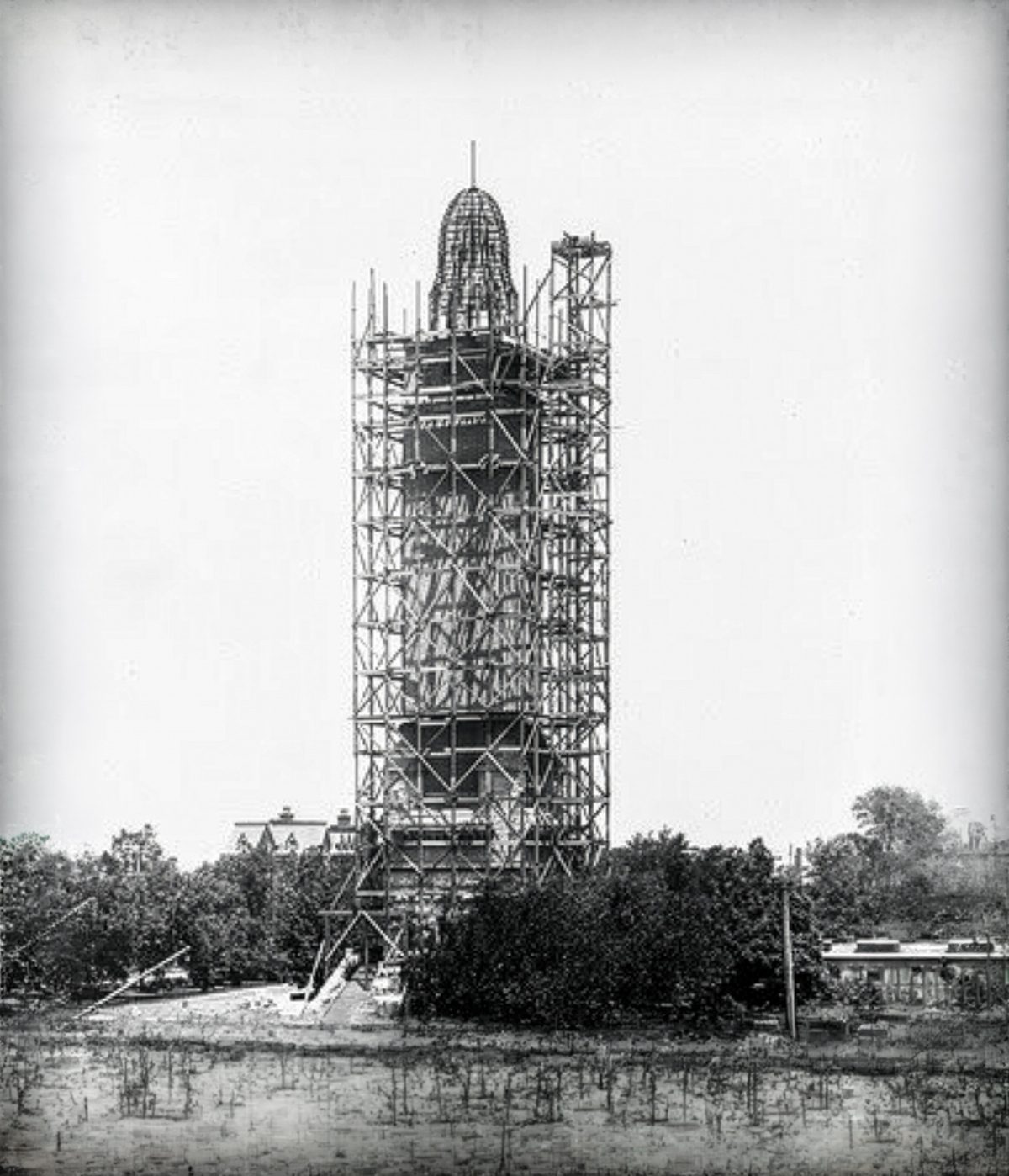 The tower nearly complete, with the crown taking shape above the scaffold